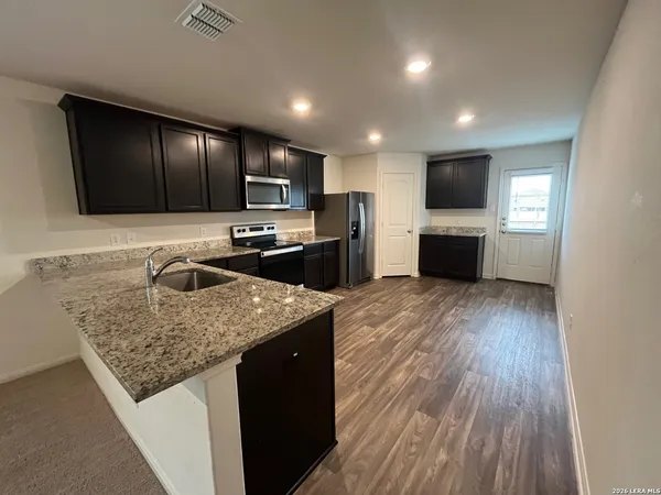 a kitchen with a sink and a stove top oven