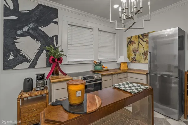 a kitchen with stainless steel appliances granite countertop a sink a stove and a refrigerator