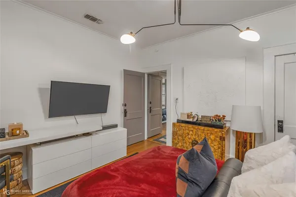 a bedroom with furniture and a flat screen tv