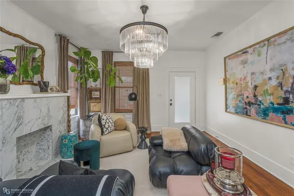 a living room with furniture and a chandelier