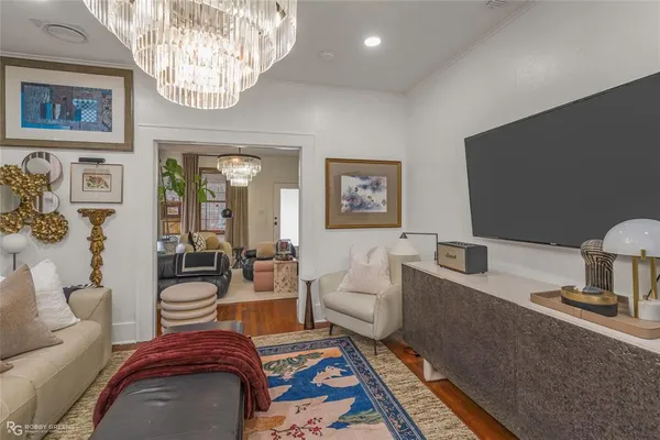 a living room with furniture and a chandelier