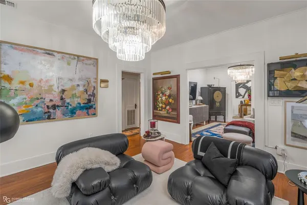 a living room with furniture chandelier and a chandelier