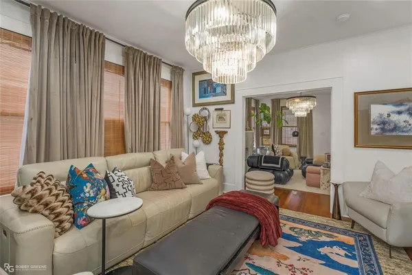 a living room with furniture and a chandelier