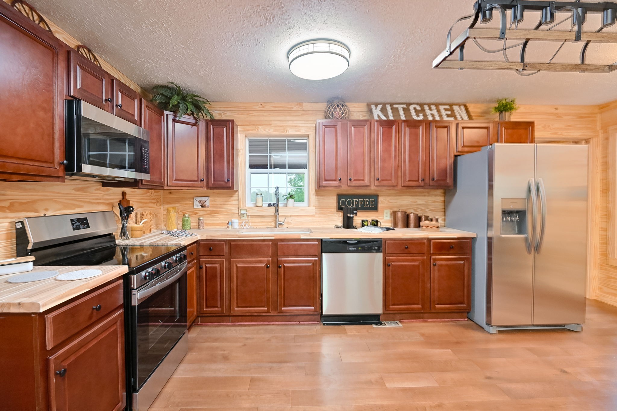 292 Harmony Road Gainesboro, TN 38562 - Photo 27 of 61 a kitchen with stainless steel appliances granite countertop a stove top oven a sink dishwasher a refrigerator and cabinets with wooden floor