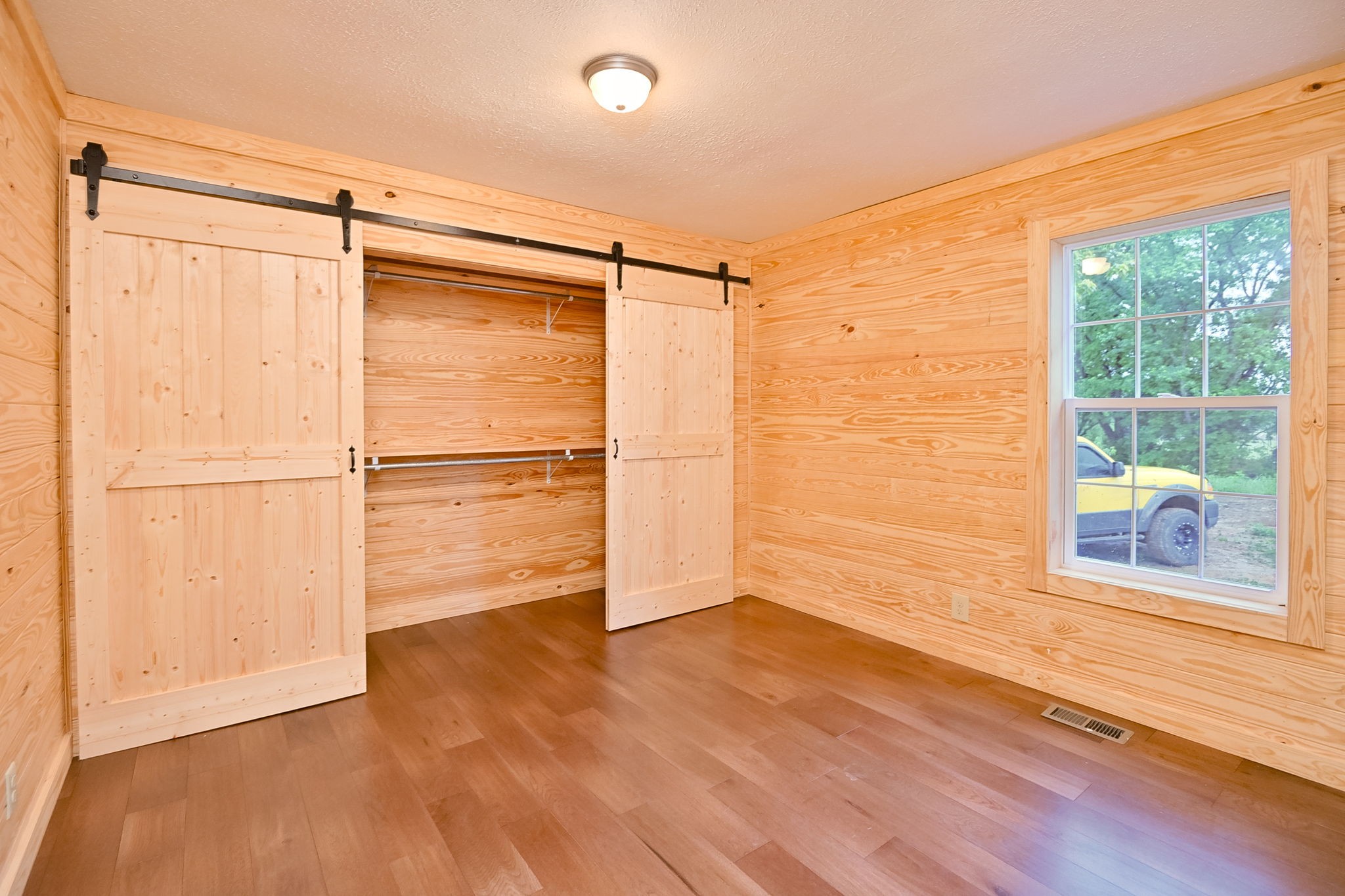 292 Harmony Road Gainesboro, TN 38562 - Photo 56 of 61 a view of an empty room with wooden floor and a window