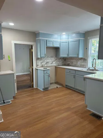 a kitchen with stainless steel appliances granite countertop a sink and cabinets
