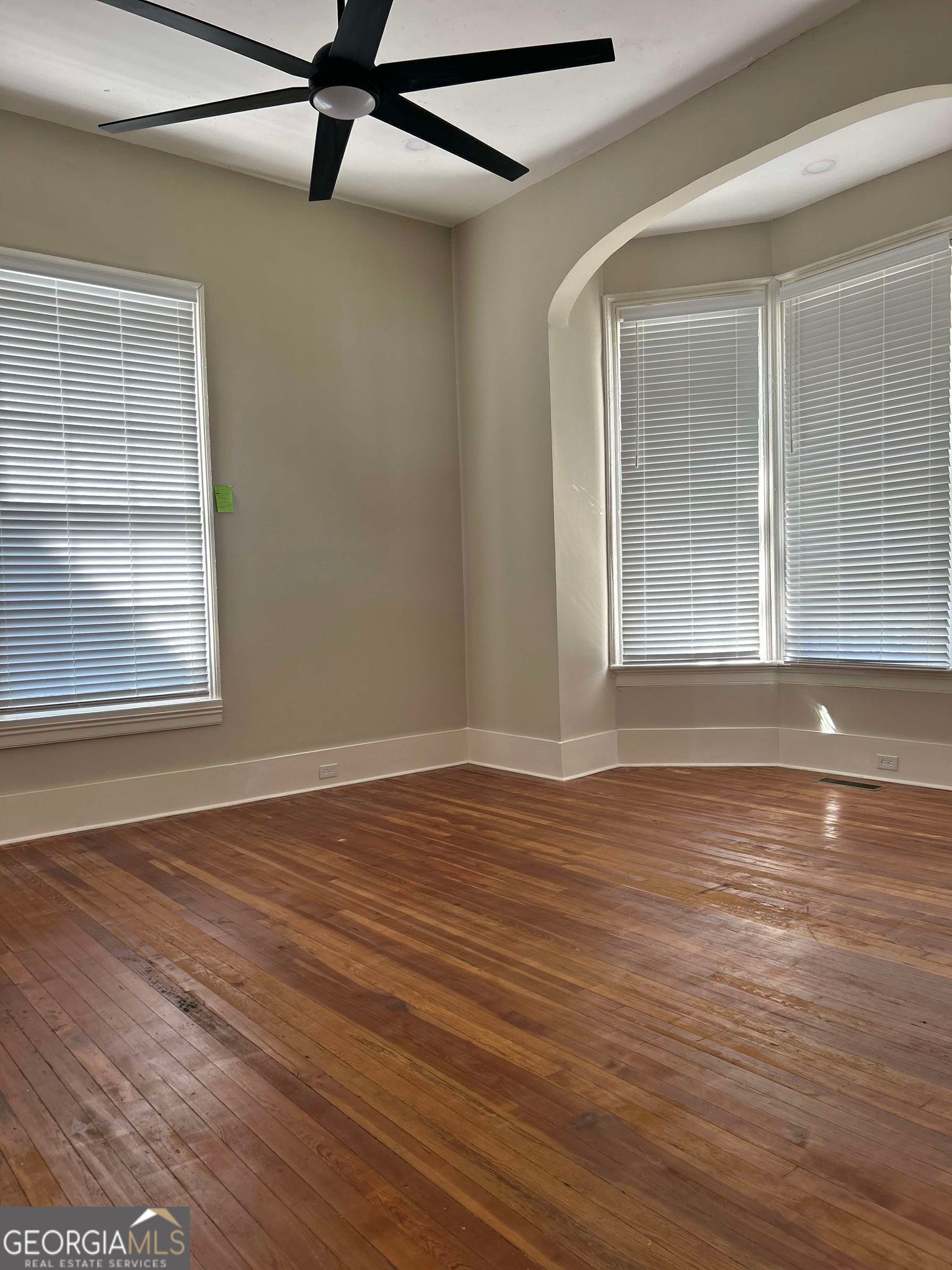 1428 2nd Street Macon, GA 31201 - Photo 7 of 10 a view of an empty room with wooden floor and a window