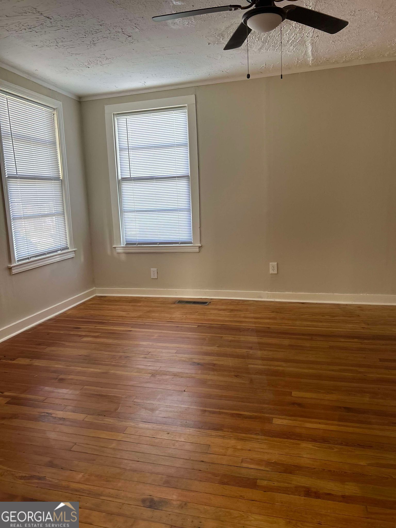1428 2nd Street Macon, GA 31201 - Photo 9 of 10 an empty room with wooden floor and windows