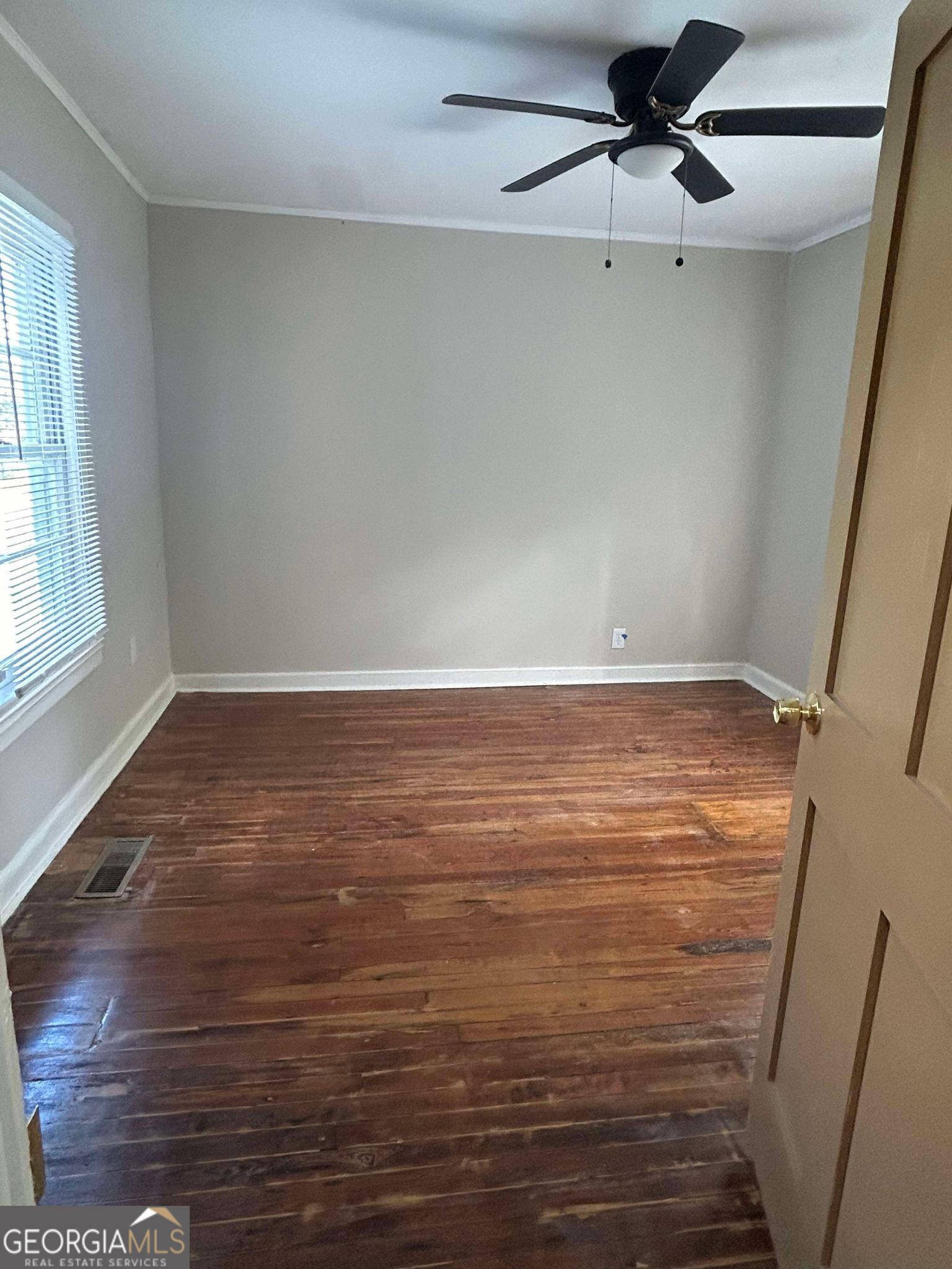 1428 2nd Street Macon, GA 31201 - Photo 10 of 10 an empty room with wooden floor fan and windows