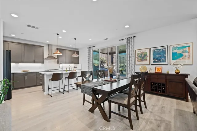 a large kitchen with a table and chairs