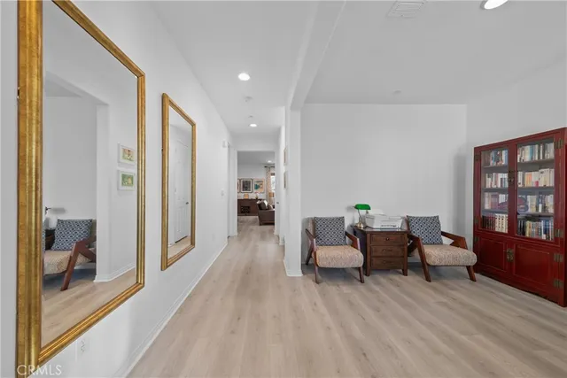 a hall way with furniture and a wooden floor