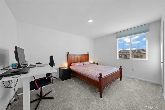 a bedroom with bed and a window