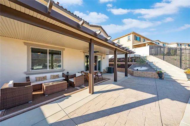 a view of a patio with a table and chairs