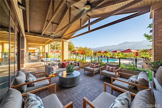 a living room with patio furniture and a large window