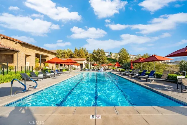 a swimming pool with outdoor seating and yard