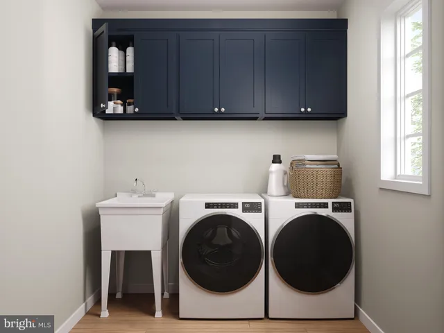a utility room with sink dryer and washer