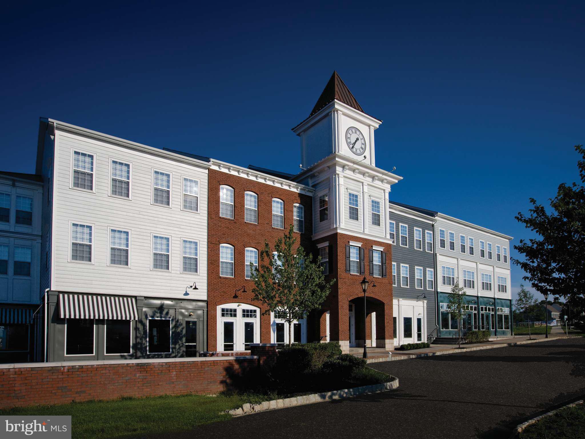 104 Merchant Avenue, Unit DUNDEE Mount Joy, PA 17552 - Photo 29 of 40 a front view of a building with lot of cars and trees