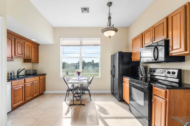 a dining room with furniture a chandelier and wooden floor