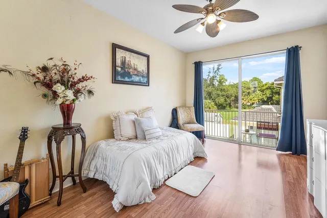 a bedroom with a large bed and a chandelier