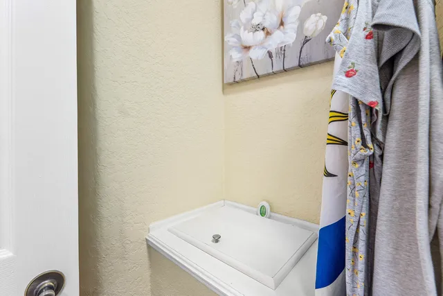 a bathroom with a white tub and shower