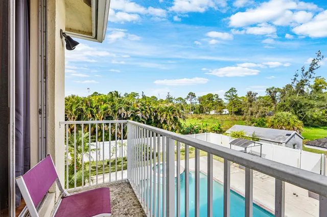 a view of a balcony with wooden fence