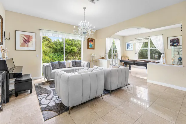 a living room with furniture and a chandelier