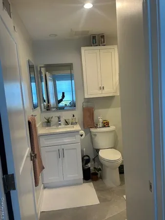 a bathroom with a sink toilet and mirror