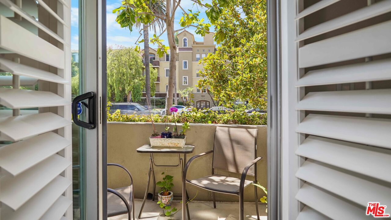 2240 South Beverly Glen Boulevard, Unit 103 Los Angeles, CA 90064 - Photo 14 of 27 a outdoor dining room with furniture and a floor to ceiling window