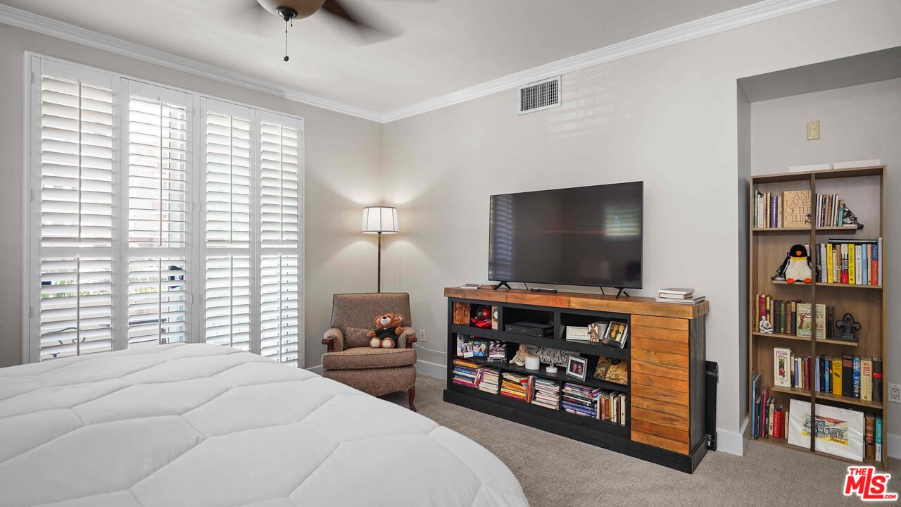 2240 South Beverly Glen Boulevard, Unit 103 Los Angeles, CA 90064 - Photo 20 of 27 a bedroom with furniture and a flat screen tv
