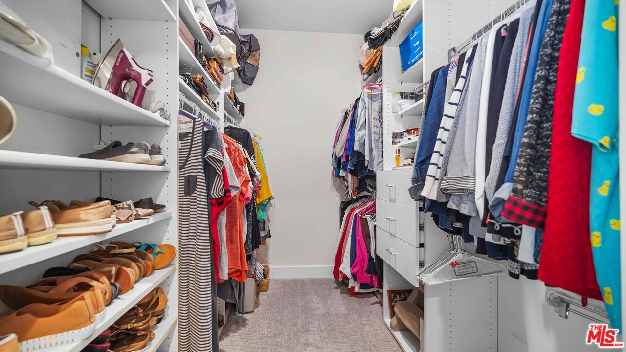 2240 South Beverly Glen Boulevard, Unit 103 Los Angeles, CA 90064 - Photo 23 of 27 a view of walk in closet with clothes and shoes