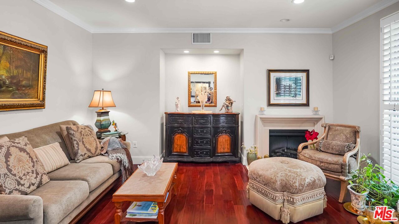2240 South Beverly Glen Boulevard, Unit 103 Los Angeles, CA 90064 - Photo 4 of 27 a living room with furniture and a fireplace