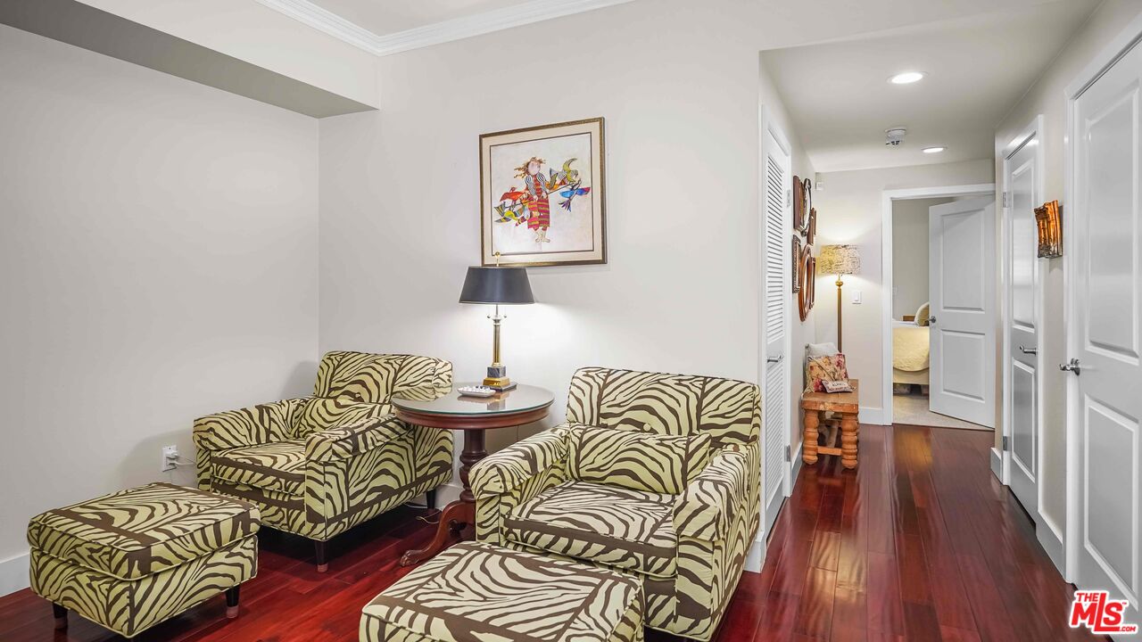 2240 South Beverly Glen Boulevard, Unit 103 Los Angeles, CA 90064 - Photo 7 of 27 a bedroom with furniture and a wooden floor