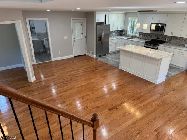 a kitchen with a sink appliances and cabinets