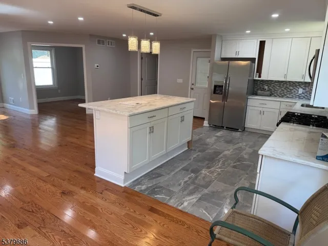 a kitchen with a refrigerator and a stove top oven