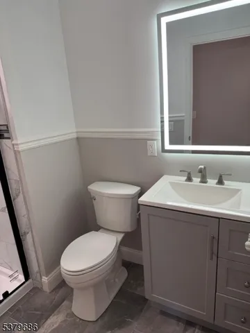 a bathroom with a shower and toilet