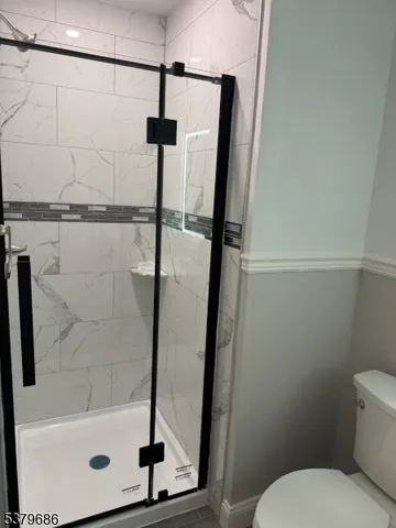 a view of room with window and wooden floor