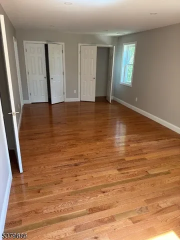 a view of room with window and wooden floor