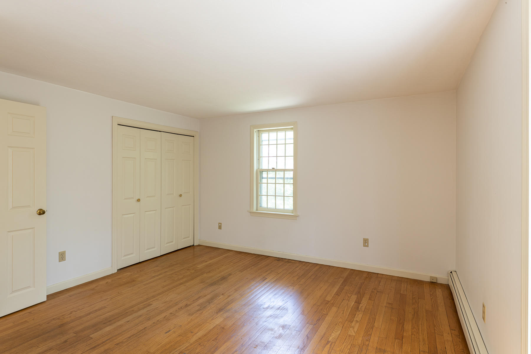 54 Crawford Road Cotuit, MA 02635 - Photo 18 of 46 an empty room with wooden floor and windows