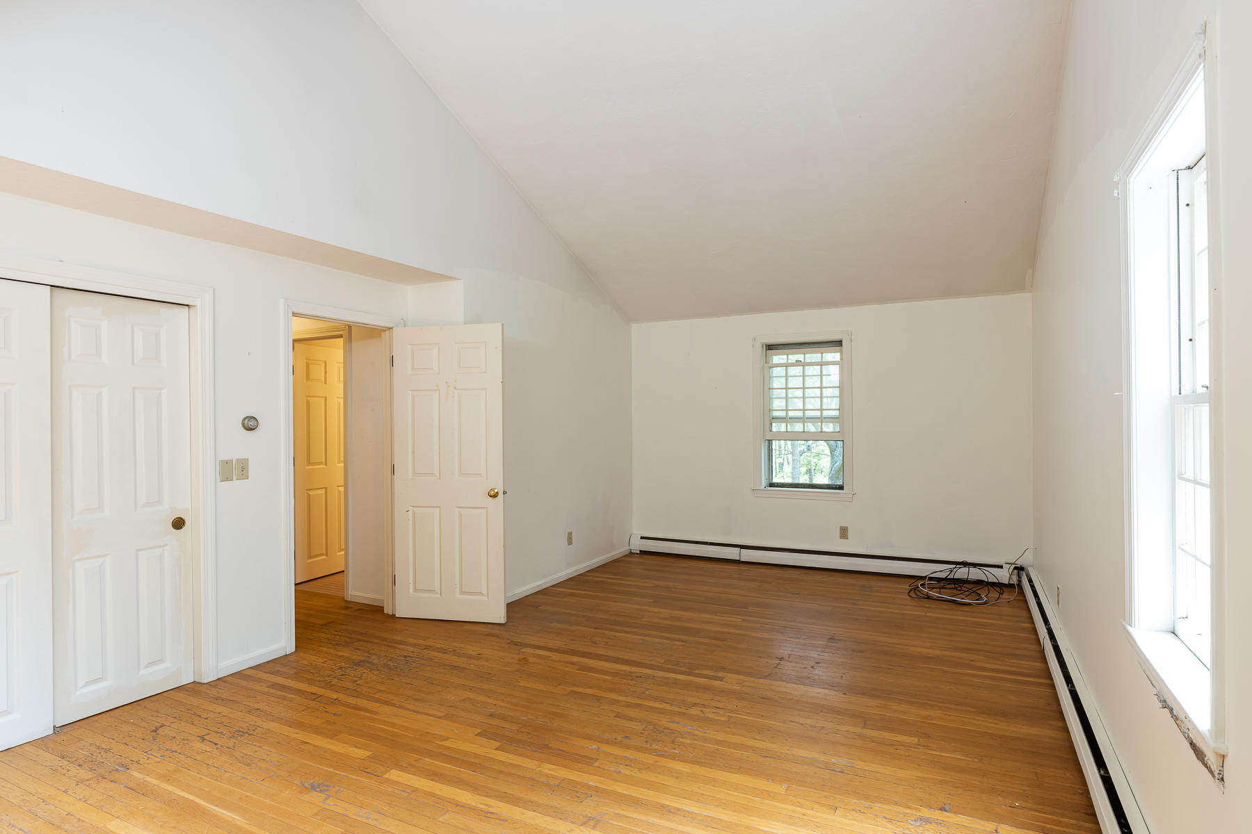 54 Crawford Road Cotuit, MA 02635 - Photo 23 of 46 a view of an empty room with wooden floor and a window