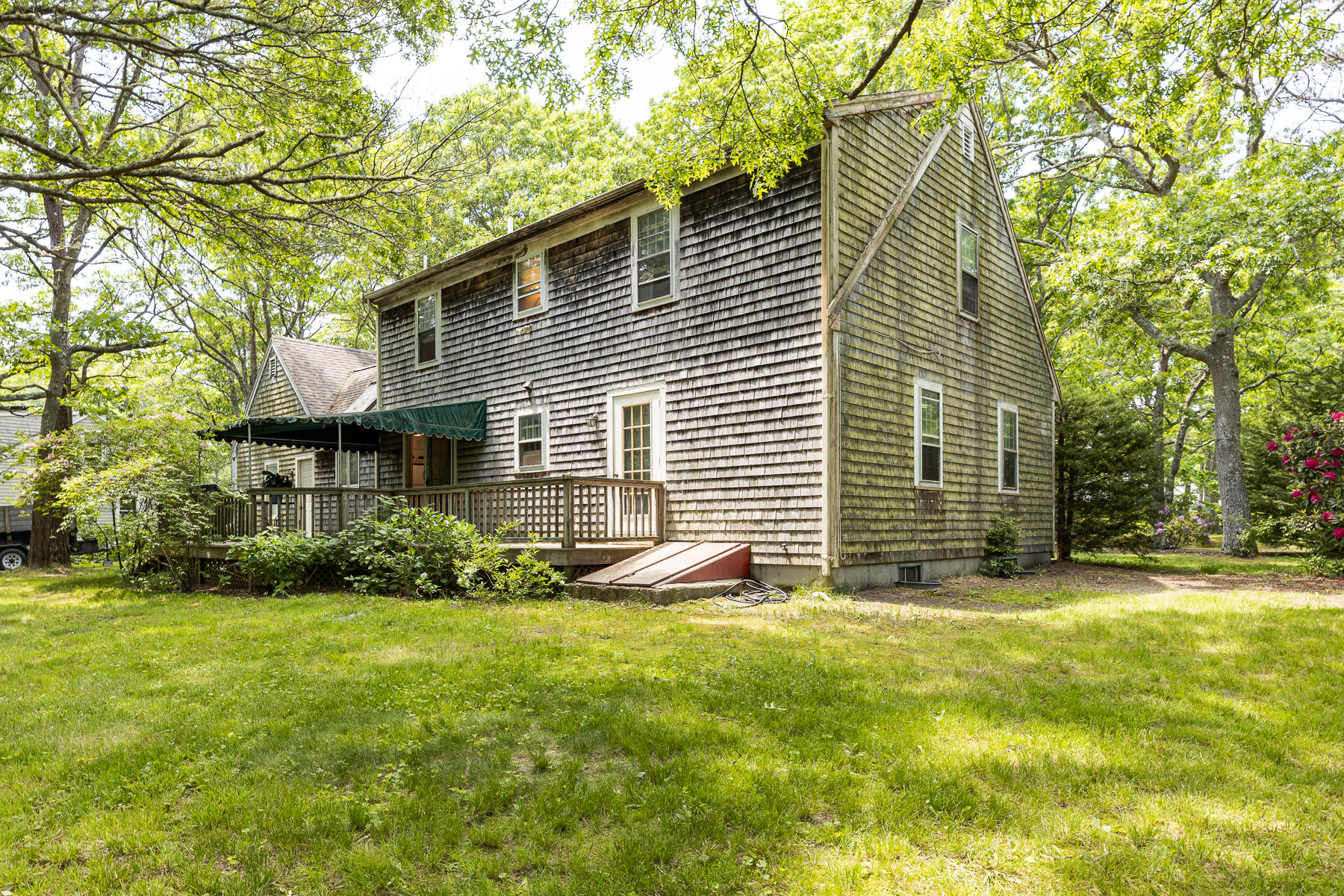 54 Crawford Road Cotuit, MA 02635 - Photo 34 of 46 a front view of a house with a yard and garage