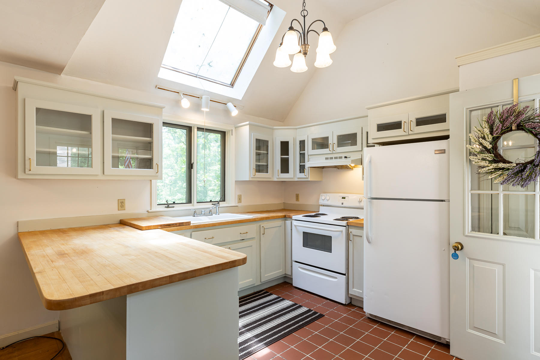 54 Crawford Road Cotuit, MA 02635 - Photo 4 of 46 a kitchen with stainless steel appliances granite countertop a sink stove and refrigerator