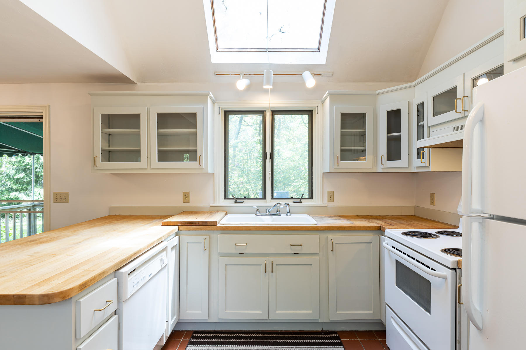 54 Crawford Road Cotuit, MA 02635 - Photo 5 of 46 a kitchen with granite countertop a sink and a window