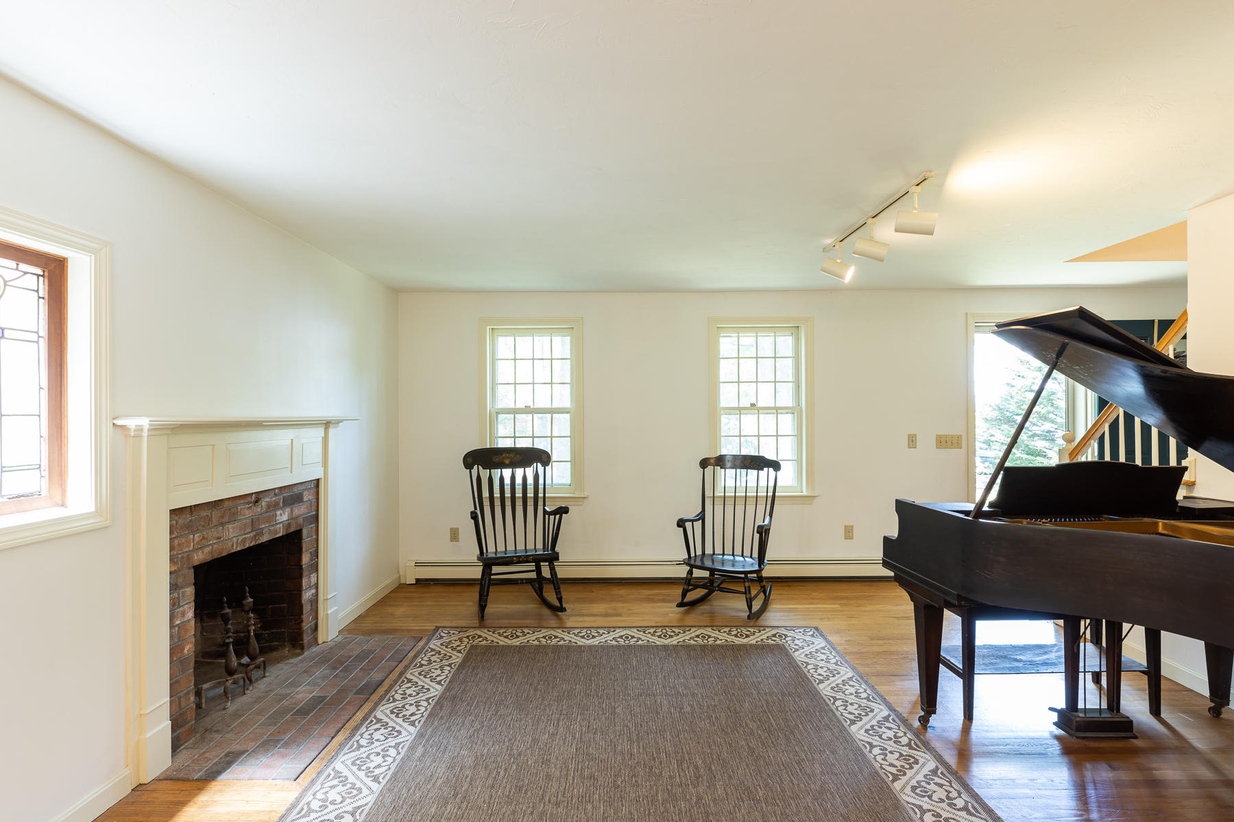 54 Crawford Road Cotuit, MA 02635 - Photo 10 of 46 a living room with furniture and a fireplace