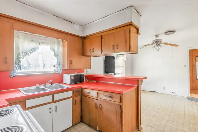 a kitchen with a stove a sink and a refrigerator