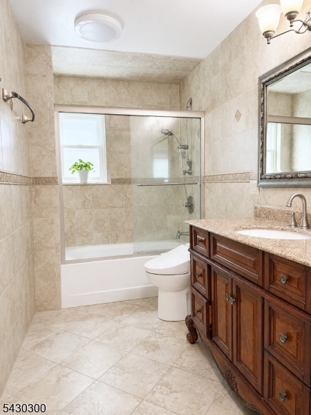 25 Spring Street, Unit A Millburn, NJ 07041 - Photo 12 of 21 a bathroom with a sink a toilet and bathtub