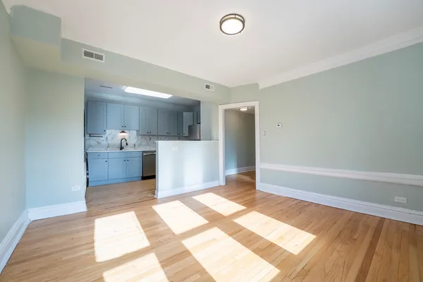a view of a kitchen with wooden floor and a kitchen space