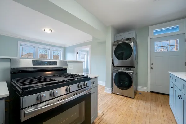 a kitchen with wooden floor and a stove top oven