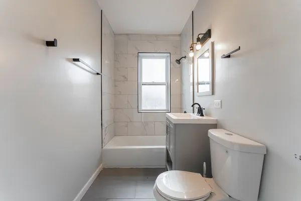 a bathroom with a sink toilet and shower