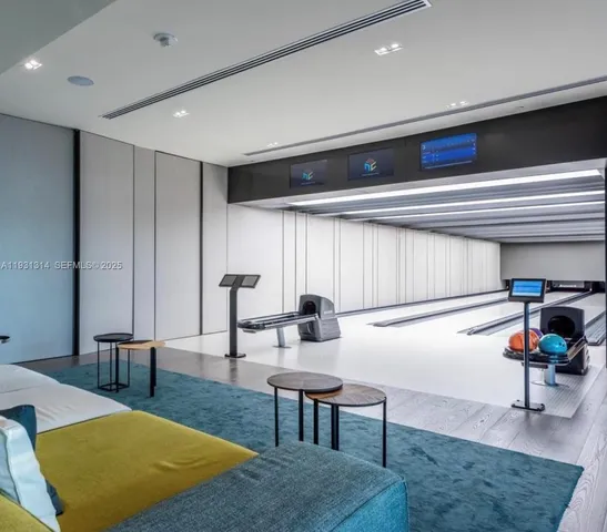 a living room with furniture and large windows