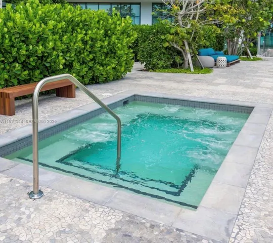 a living room with couches and projector with a flat screen tv